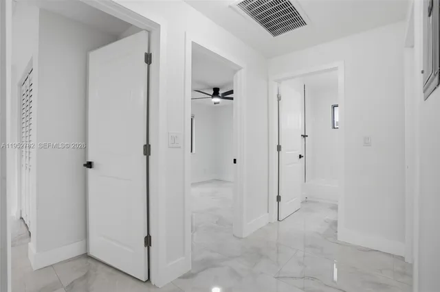 an empty room with a ceiling fan