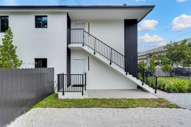 a kitchen with a refrigerator a sink a stove and cabinets