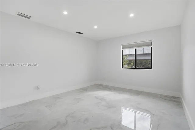 a kitchen with stainless steel appliances granite countertop a sink a stove and refrigerator