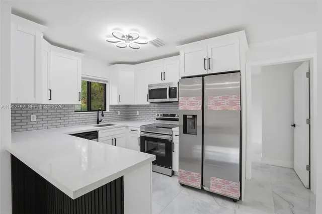 a bathroom with a bathtub shower sink vanity and toilet