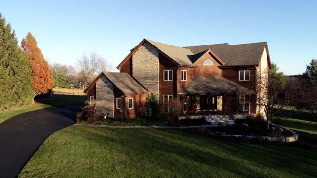 a front view of house with a garden