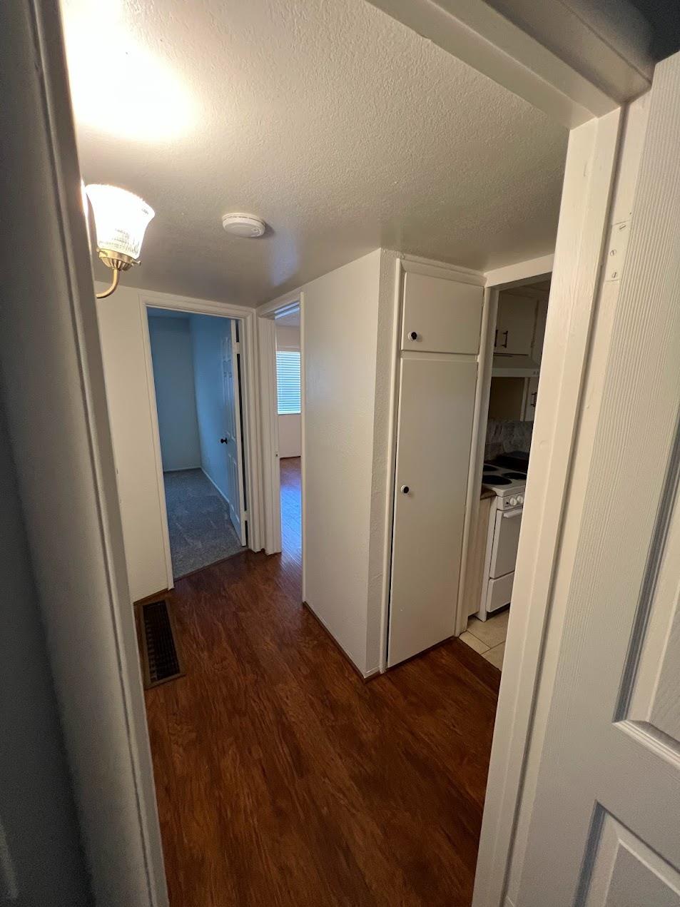 1205 F Street Reedley, CA 93654 - Photo 17 of 34 an empty room with wooden floor and a window