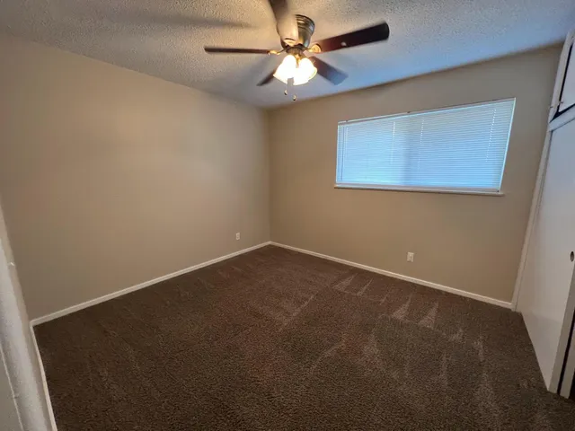 a view of an empty room with a kitchen