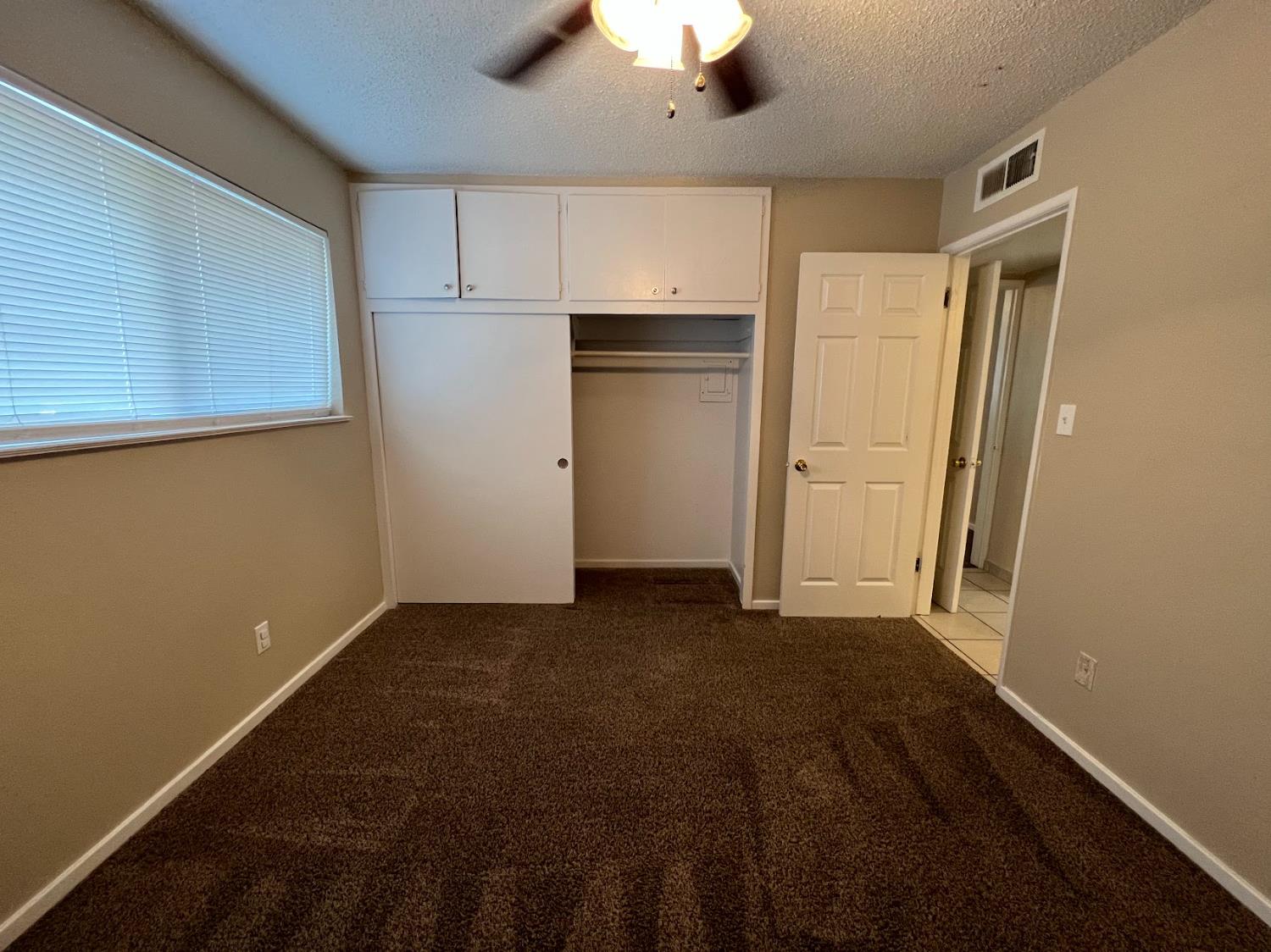 1205 F Street Reedley, CA 93654 - Photo 27 of 34 a view of an empty room with a kitchen