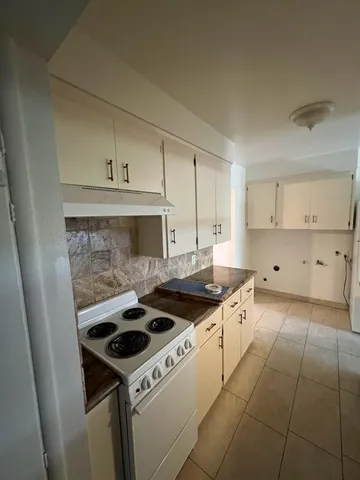 a view of a kitchen with a sink cabinets and a window