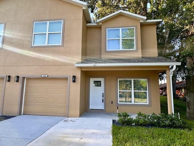 a front view of a house with a yard and garage