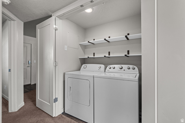 1700 South Sandhill Road West, Unit E 301 Orem, UT 84058 - Photo 16 of 20 Dedicated laundry closet featuring a washer and dryer, complemented by two levels of built-in shelving with black support brackets