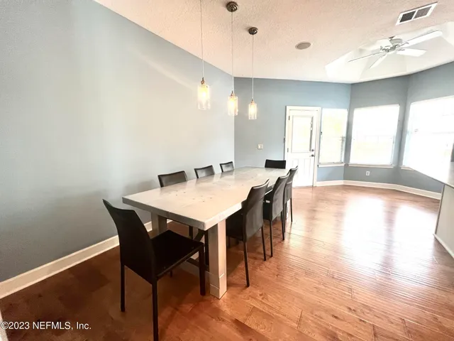 a view of a dining room with furniture and wooden floor
