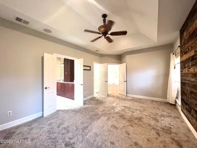 a view of a livingroom with a flat screen tv and a ceiling fan
