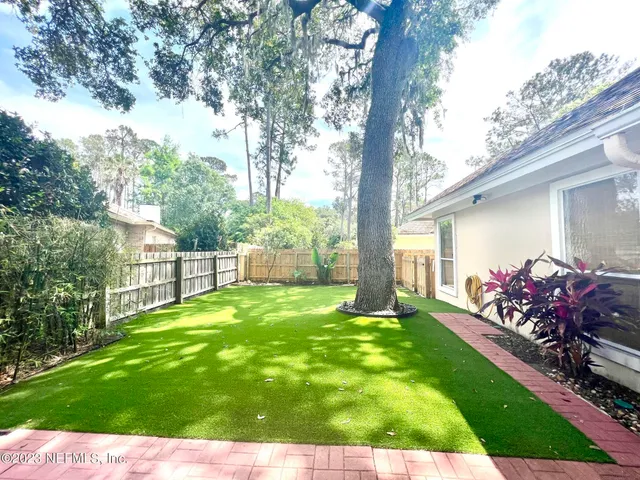 a view of a backyard with garden and plants