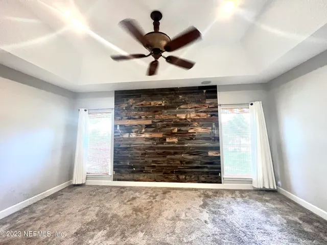 a view of room with a ceiling fan and window