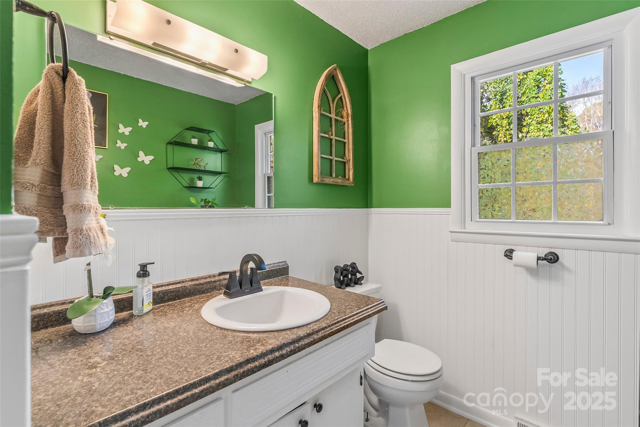 320 Morehead St Extension Morganton, NC 28655 - Photo 14 of 33 a bathroom with a granite countertop toilet a sink and a mirror