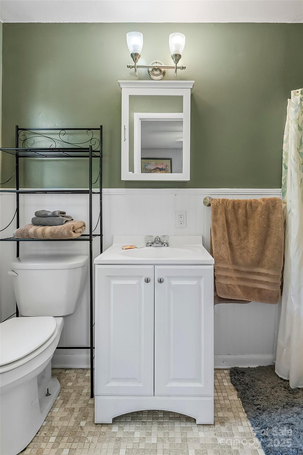 320 Morehead St Extension Morganton, NC 28655 - Photo 16 of 33 a bathroom with a toilet sink and mirror