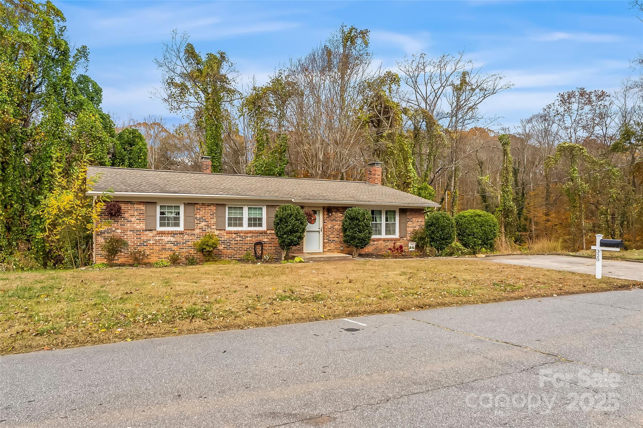 320 Morehead St Extension Morganton, NC 28655 - Photo 3 of 33 a front view of a house with a yard and trees