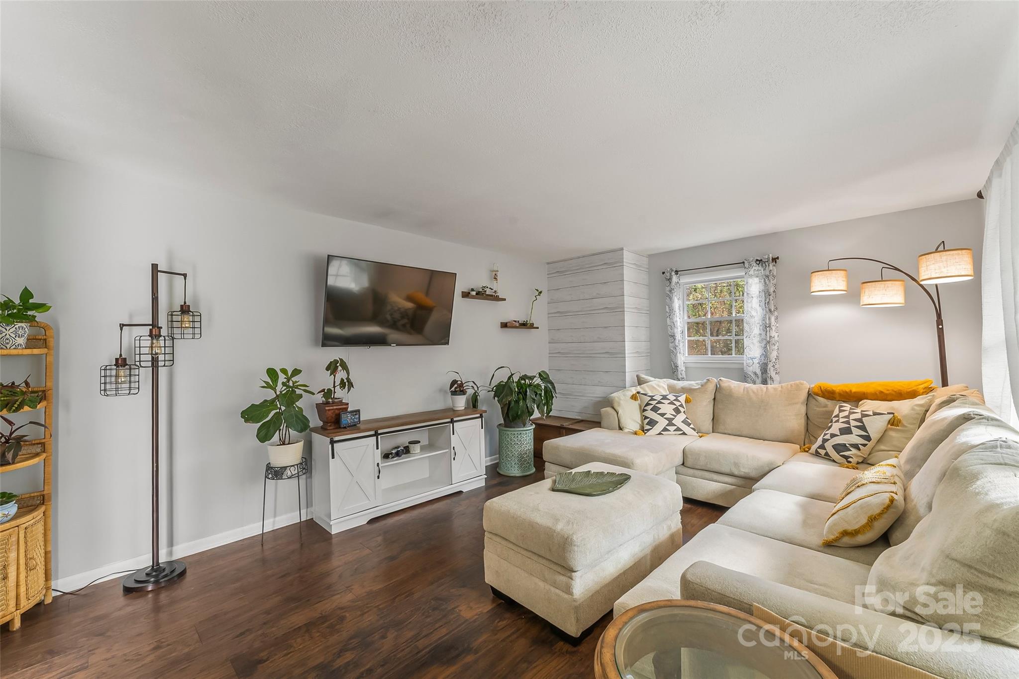 320 Morehead St Extension Morganton, NC 28655 - Photo 6 of 33 a living room with furniture a flat screen tv and a potted plant