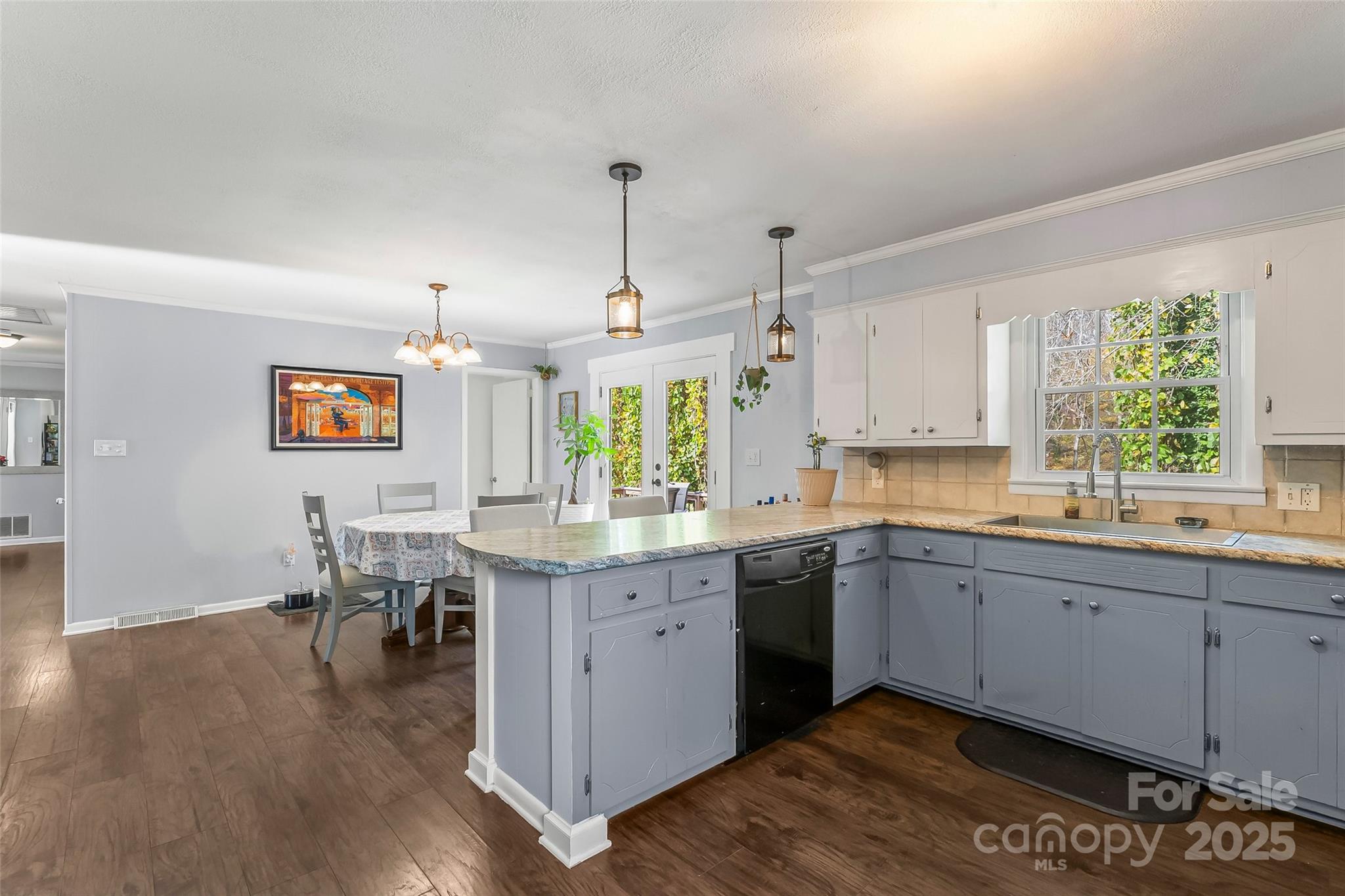 320 Morehead St Extension Morganton, NC 28655 - Photo 9 of 33 a large kitchen with cabinets chairs and wooden floor