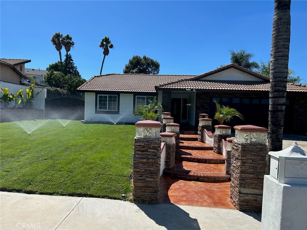 8138 Camelot Road Riverside, CA 92503 - Photo 1 of 1 a front view of a house with garden
