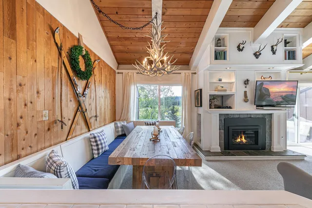 a living room with furniture fireplace and a large window