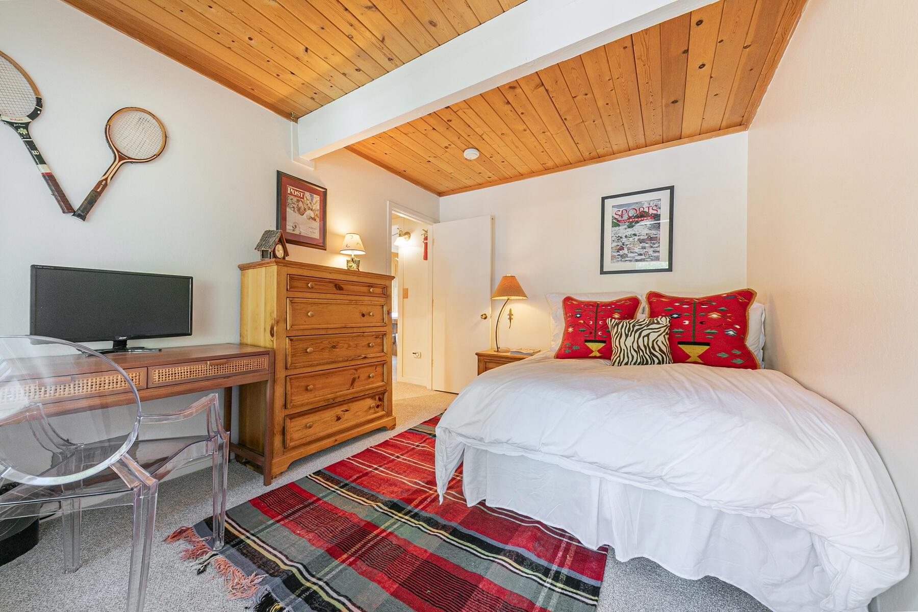 2560 Lake Forest Road, Unit 48 Tahoe City, CA 96145 - Photo 10 of 28 a bedroom with a bed and a flat screen tv