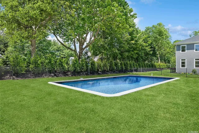 a view of a backyard with large trees