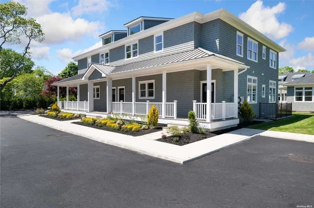 a view of a building with a large window and a yard