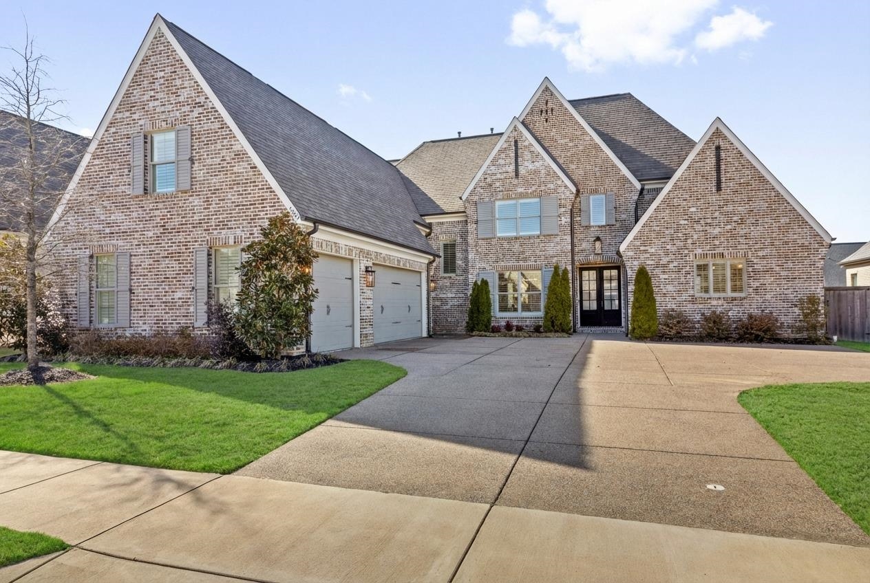 4757 Carousel Lane Collierville, TN 38017 - Photo 2 of 39 View of front of home featuring driveway, a front lawn, brick siding, and french doors
