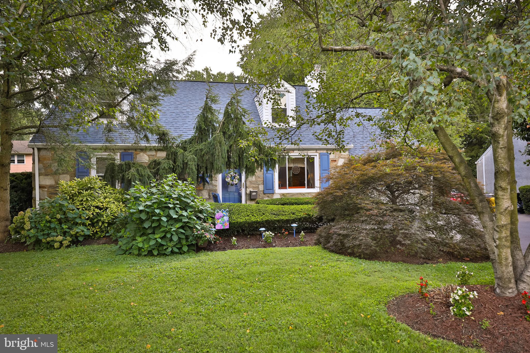 1702 Church Road Oreland, PA 19075 - Photo 1 of 28 a front view of a house with a garden