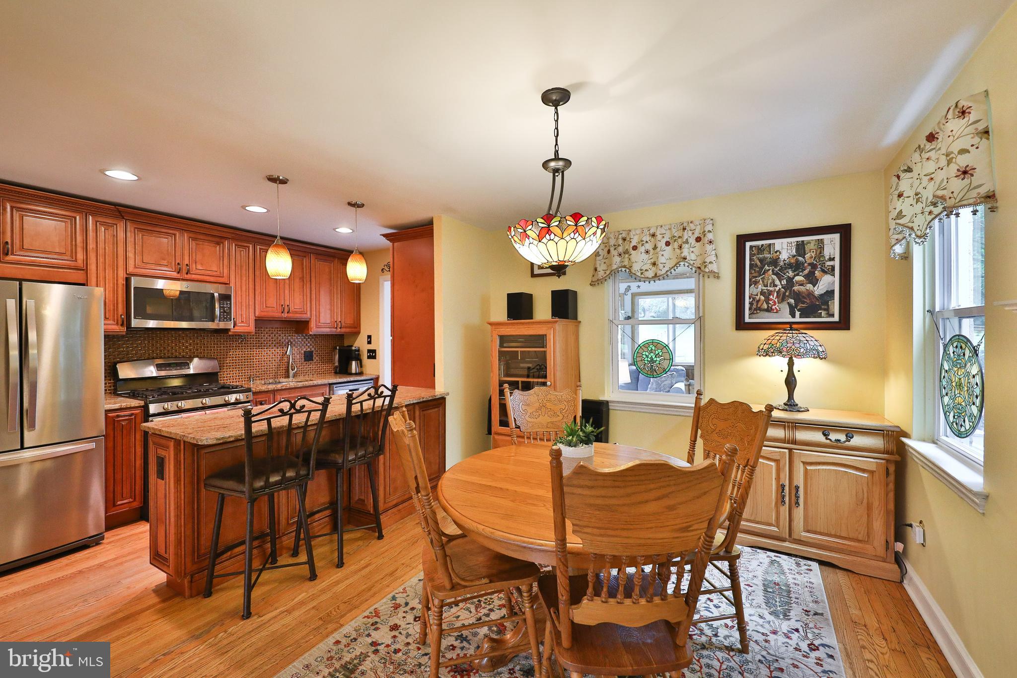 1702 Church Road Oreland, PA 19075 - Photo 8 of 28 a view of a dining room with furniture a kitchen and chandelier