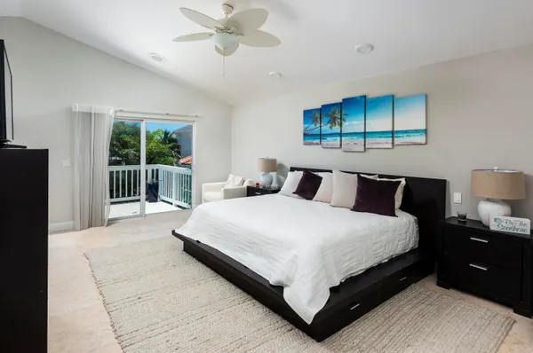 a large bedroom with a bed and window