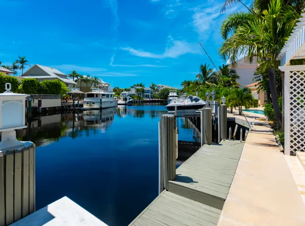 a kitchen with kitchen island granite countertop a sink stainless steel appliances and cabinets