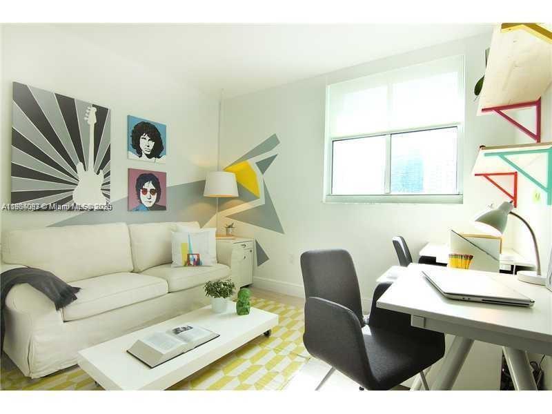 1250 South Miami Avenue, Unit 901 Miami, FL 33130 - Photo 4 of 10 a living room with furniture and a painting on the wall