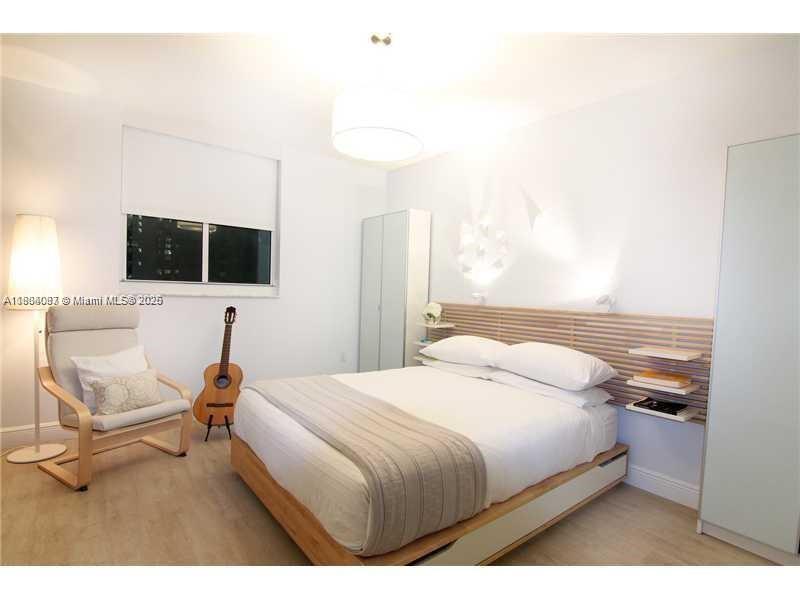 1250 South Miami Avenue, Unit 901 Miami, FL 33130 - Photo 9 of 10 a bedroom with a bed and flat screen tv