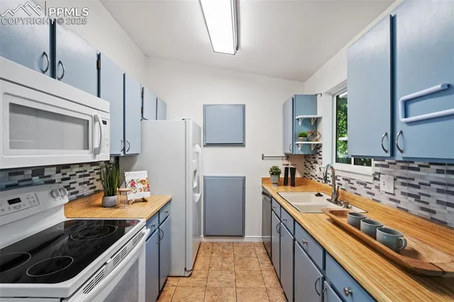 a kitchen with stainless steel appliances sink stove microwave and refrigerator