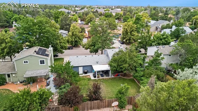 an aerial view of a house with a yard