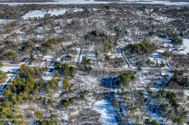an aerial view of a house with outdoor space and lake view