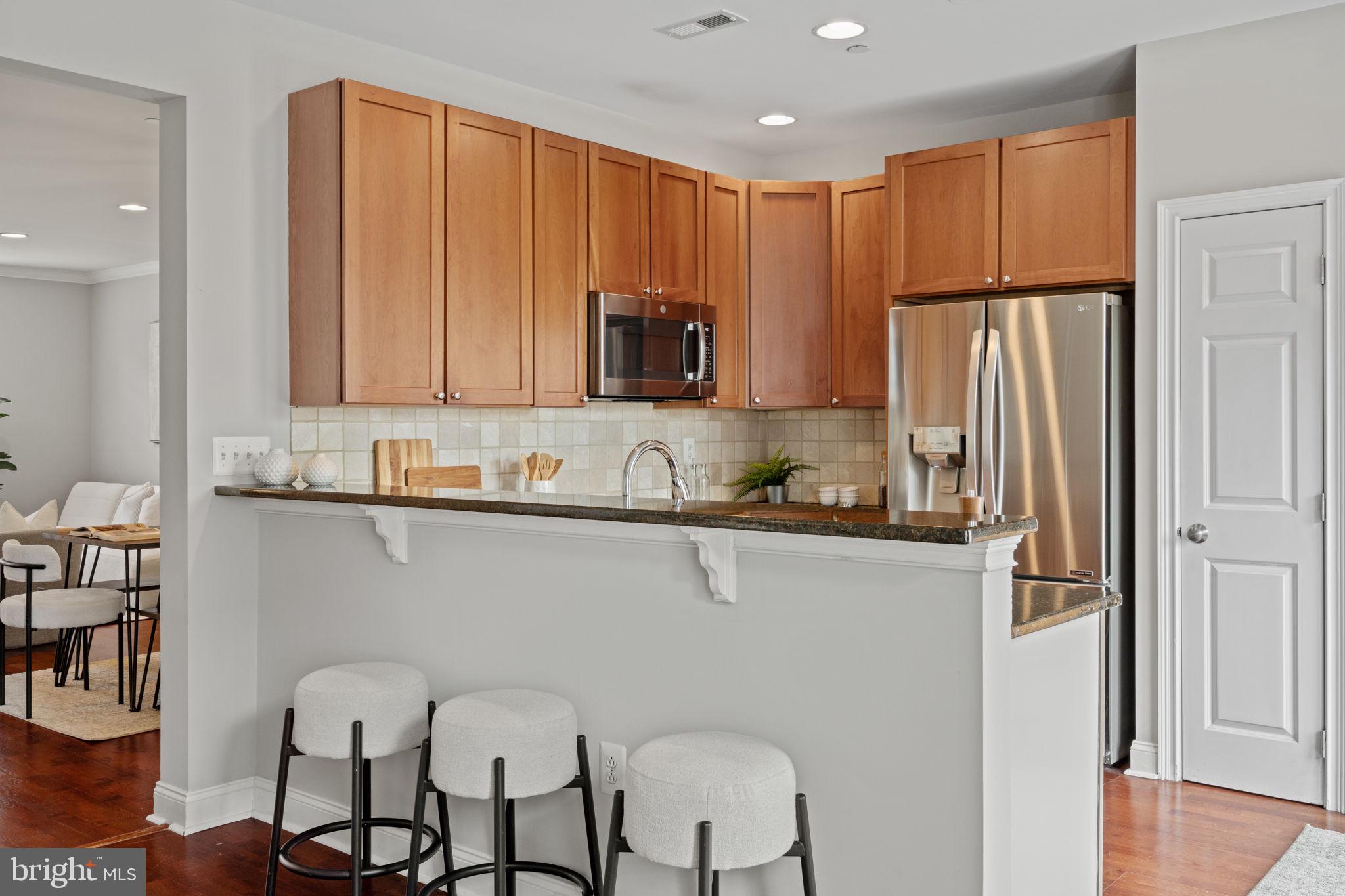 305 Captains Way Philadelphia, PA 19146 - Photo 17 of 63 a kitchen with stainless steel appliances granite countertop a refrigerator and a stove top oven