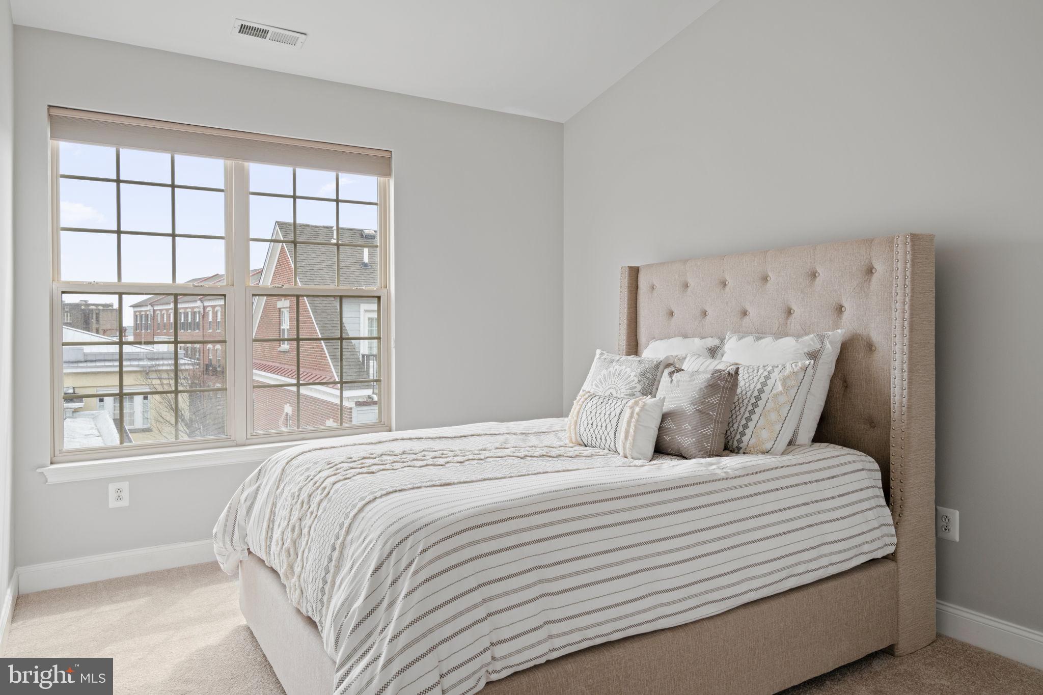 305 Captains Way Philadelphia, PA 19146 - Photo 38 of 63 a large bed sitting in a bedroom next to a window