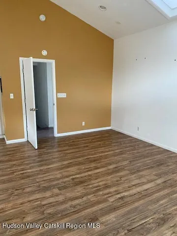 a view of a room with wooden floor