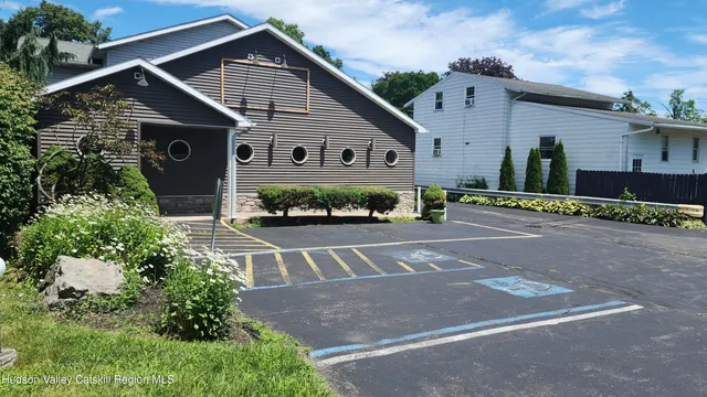 a view of a house with a yard and potted plants