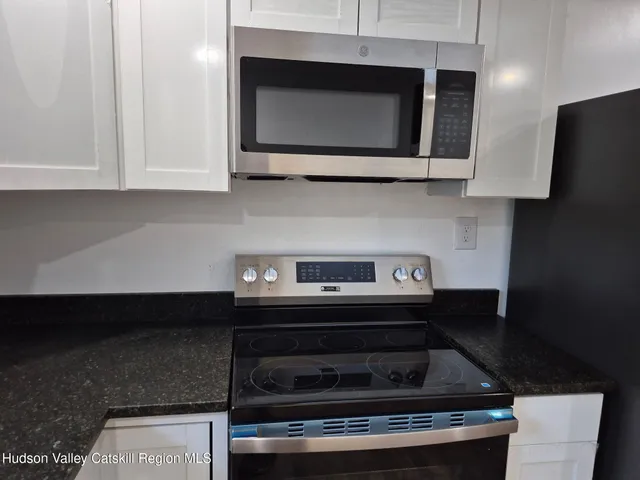 a stove top oven sitting inside of a kitchen