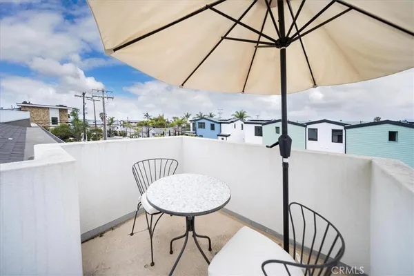 a view of a chairs and table in the balcony