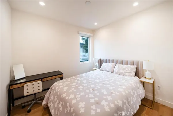 a bedroom with bed and a window