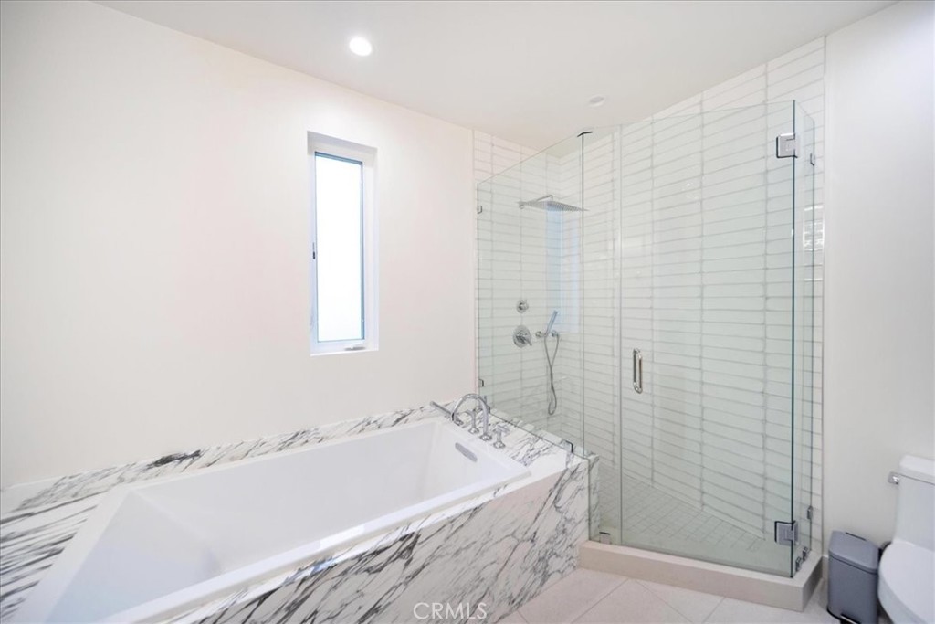 3632 Garfield Street Carlsbad, CA 92008 - Photo 38 of 50 a bathroom with a tub a toilet and a shower