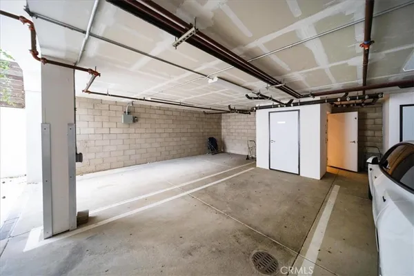 a view of a white house with a small yard and plants