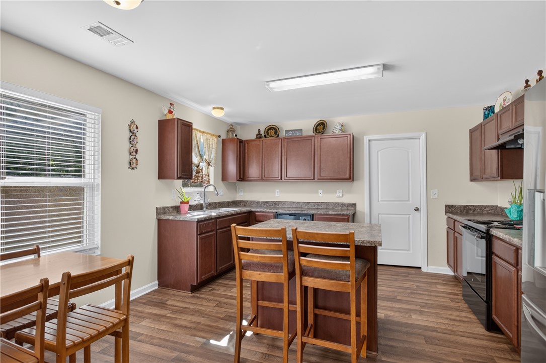 1081 Edenbrooke Circle Anderson, SC 29621 - Photo 8 of 46 A well-equipped kitchen features ample cabinet space, a central island, and modern appliances, perfect for everyday living.