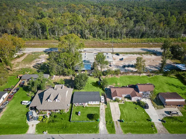 an aerial view of a house with a yard basket ball court and outdoor seating