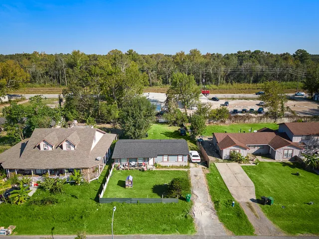 an aerial view of a house with garden space and street view