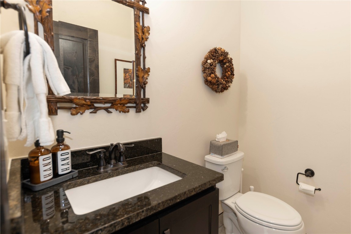 58 Erickson Loop, Unit 13A Keystone, CO 80435 - Photo 14 of 28 a bathroom with a toilet a sink and mirror
