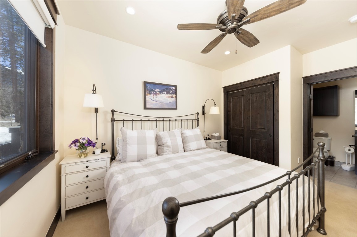 58 Erickson Loop, Unit 13A Keystone, CO 80435 - Photo 18 of 28 a bedroom with a bed and a chandelier