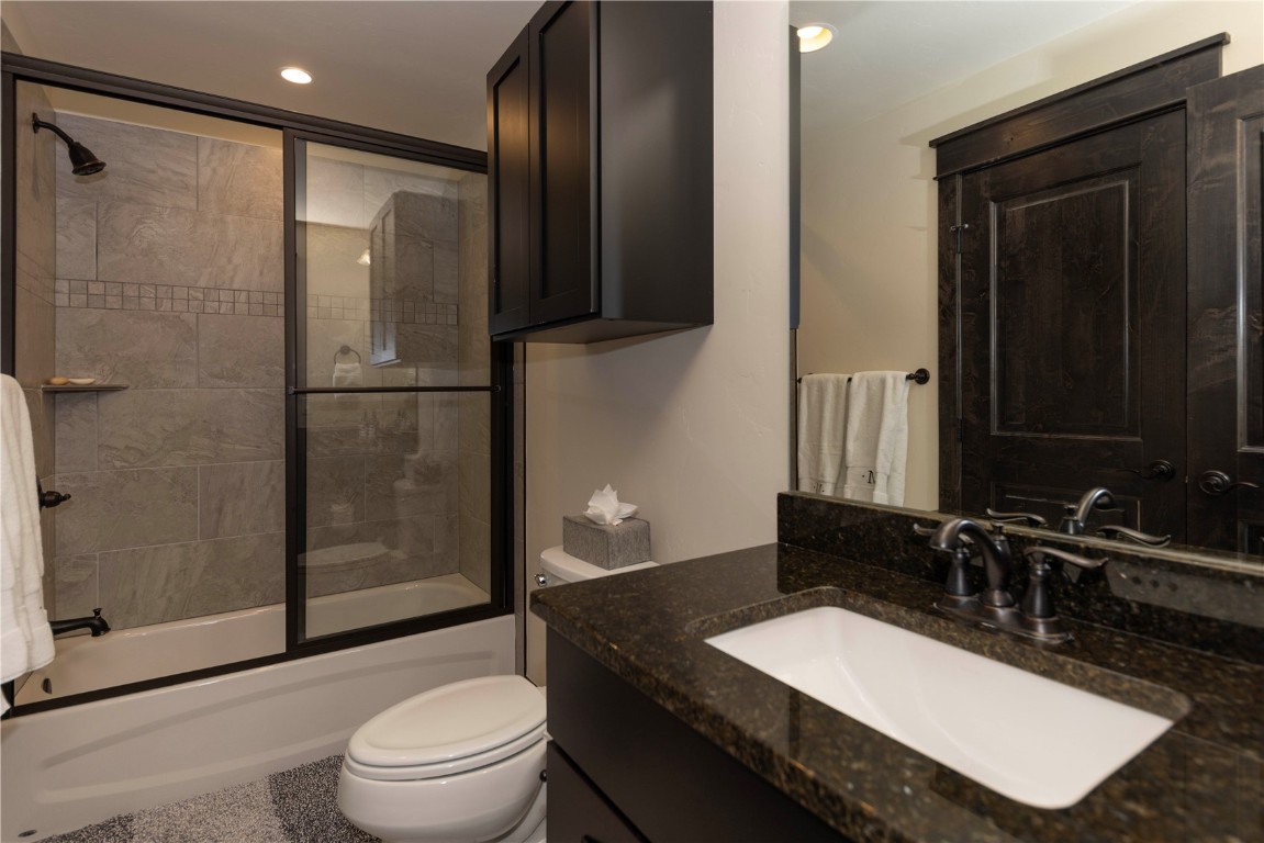 58 Erickson Loop, Unit 13A Keystone, CO 80435 - Photo 19 of 28 a bathroom with a sink a toilet and shower